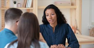 Woman talking to a few individuals